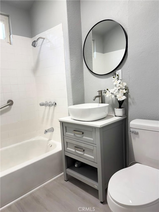 1271 N K St, San Bernardino, CA 92411 - full bathroom featuring wood finished floors, bathtub / shower combination, vanity, and a textured wall