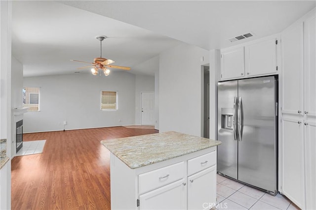14183 Gale Dr, Victorville, CA 92394 - kitchen featuring stainless steel fridge with ice dispenser, a ceiling fan, white cabinets, open floor plan, and a kitchen island
