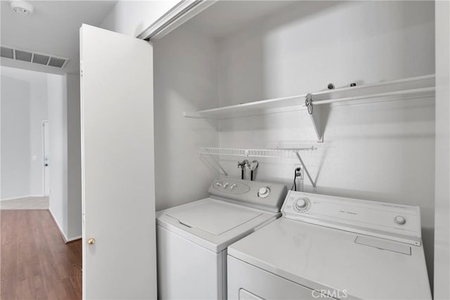 14183 Gale Dr, Victorville, CA 92394 - laundry area featuring washing machine and clothes dryer and wood finished floors