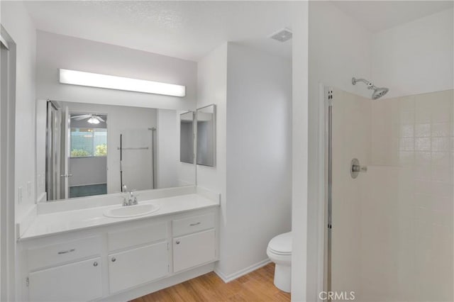 14183 Gale Dr, Victorville, CA 92394 - full bathroom with a shower stall, wood finished floors, vanity, and ceiling fan