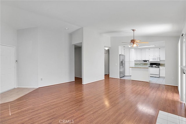 14183 Gale Dr, Victorville, CA 92394 - unfurnished living room featuring a ceiling fan and light wood-style floors