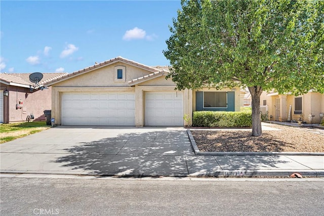 14183 Gale Dr, Victorville, CA 92394 - view of front of property with stucco siding, a garage, concrete driveway, and a tiled roof
