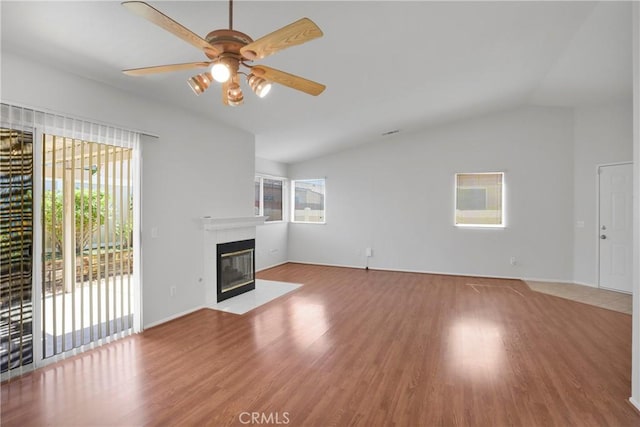 14183 Gale Dr, Victorville, CA 92394 - unfurnished living room featuring lofted ceiling, a tile fireplace, wood finished floors, and ceiling fan