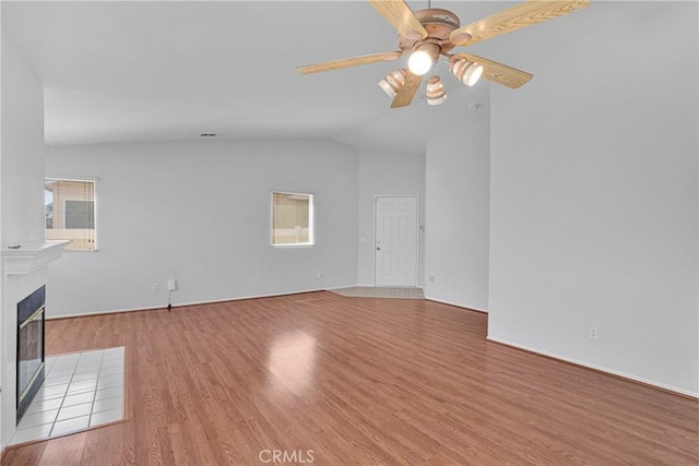 14183 Gale Dr, Victorville, CA 92394 - unfurnished living room featuring ceiling fan, wood finished floors, a fireplace, and lofted ceiling
