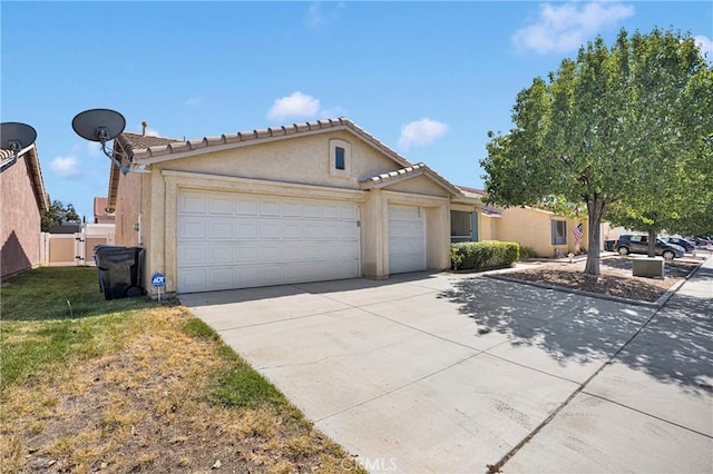 14183 Gale Dr, Victorville, CA 92394 - view of front of property featuring an attached garage, stucco siding, driveway, a tile roof, and a front yard