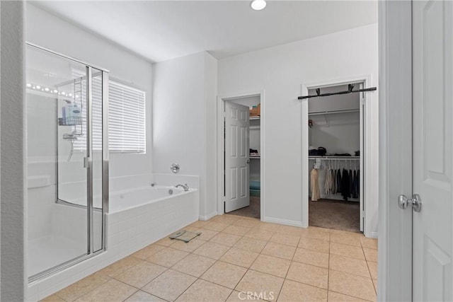 3020 Peaceful Way, Lancaster, CA 93535 - bathroom with a stall shower, a spacious closet, a bath, and tile patterned floors