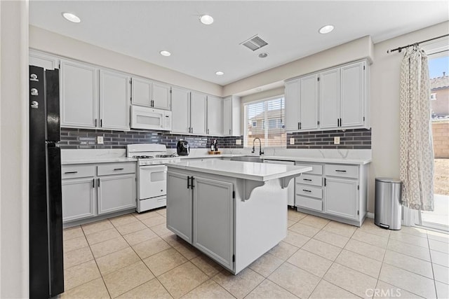 3020 Peaceful Way, Lancaster, CA 93535 - kitchen featuring white appliances, plenty of natural light, light countertops, backsplash, and recessed lighting
