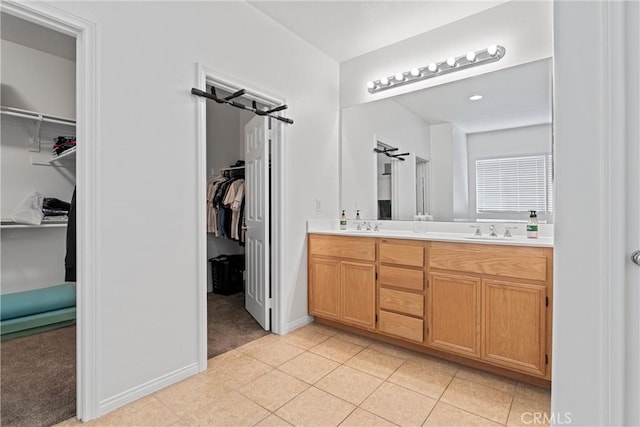 3020 Peaceful Way, Lancaster, CA 93535 - full bath featuring double vanity, a spacious closet, and tile patterned flooring