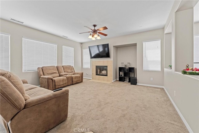 3020 Peaceful Way, Lancaster, CA 93535 - living room with a tiled fireplace, ceiling fan, and carpet flooring