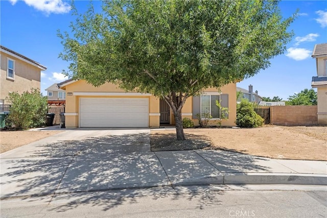 3020 Peaceful Way, Lancaster, CA 93535 - obstructed view of property featuring driveway, an attached garage, and stucco siding