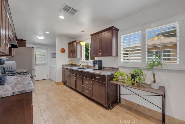 10923 Haskell Ave, Granada Hills, CA 91344 - kitchen featuring washer and dryer, dark brown cabinetry, light wood-type flooring, healthy amount of natural light, and recessed lighting