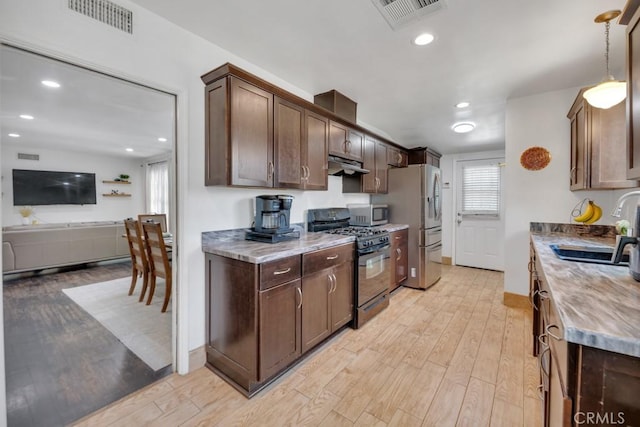 10923 Haskell Ave, Granada Hills, CA 91344 - kitchen featuring stainless steel appliances, light wood-style flooring, dark brown cabinets, and recessed lighting