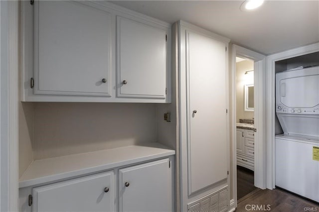 24297 El Pilar, Laguna Niguel, CA 92677 - washroom featuring stacked washer / drying machine, dark wood-style flooring, and cabinet space