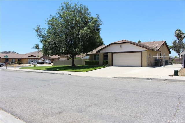 10768 William Ave, Bloomington, CA 92316 - ranch-style home with an attached garage, concrete driveway, a tiled roof, and stucco siding