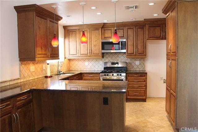 10768 William Ave, Bloomington, CA 92316 - kitchen with appliances with stainless steel finishes, hanging light fixtures, dark stone counters, brown cabinets, and decorative backsplash