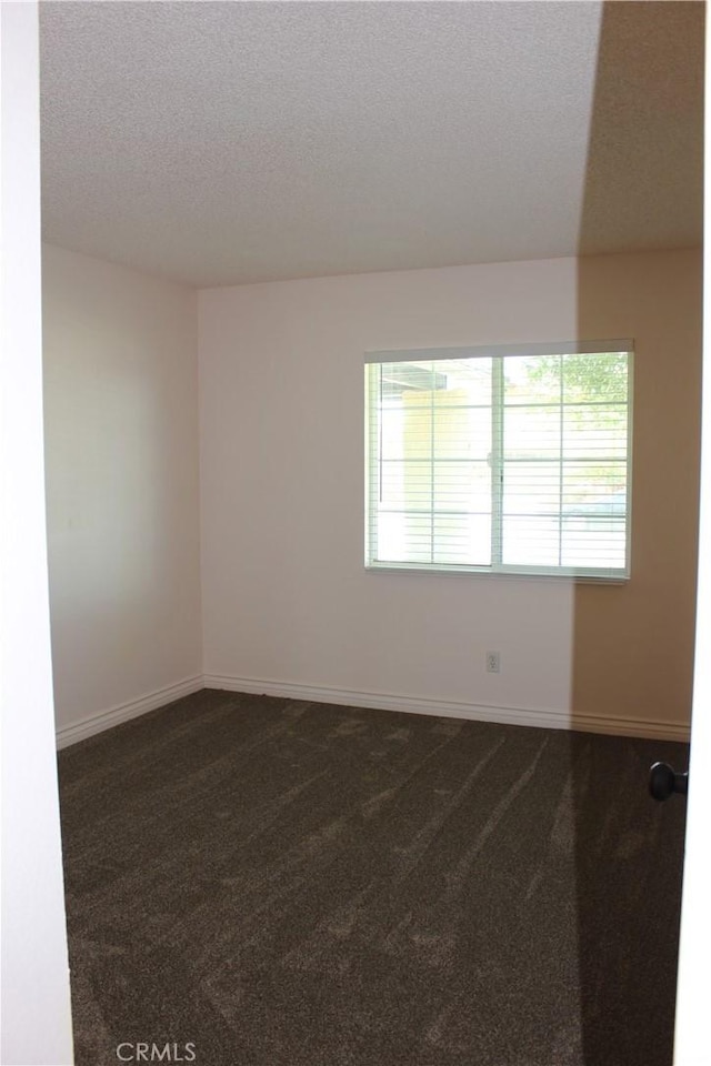 10768 William Ave, Bloomington, CA 92316 - empty room with dark carpet and a textured ceiling