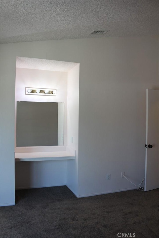 10768 William Ave, Bloomington, CA 92316 - empty room featuring dark colored carpet and a textured ceiling
