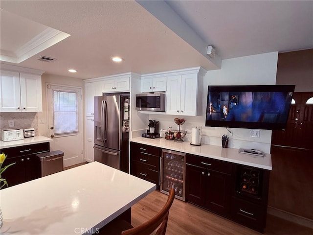 12314 Edgefield St, Cerritos, CA 90703 - kitchen featuring stainless steel appliances, wine cooler, light countertops, white cabinets, and recessed lighting