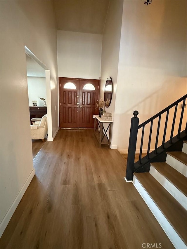 12314 Edgefield St, Cerritos, CA 90703 - foyer entrance with a high ceiling, wood finished floors, and stairs