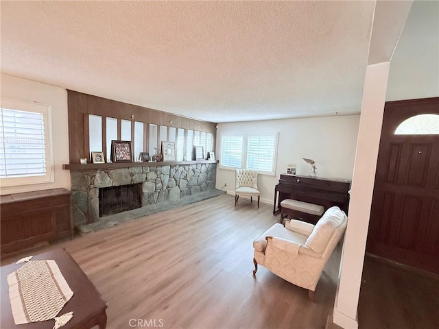 12314 Edgefield St, Cerritos, CA 90703 - living room with a textured ceiling, wood finished floors, plenty of natural light, and a fireplace