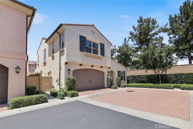 41 Somerton, Irvine, CA 92620 - mediterranean / spanish-style home with decorative driveway, stucco siding, and a garage