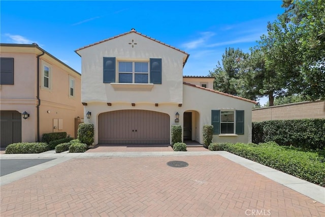 41 Somerton, Irvine, CA 92620 - mediterranean / spanish house with decorative driveway, stucco siding, an attached garage, and a tiled roof