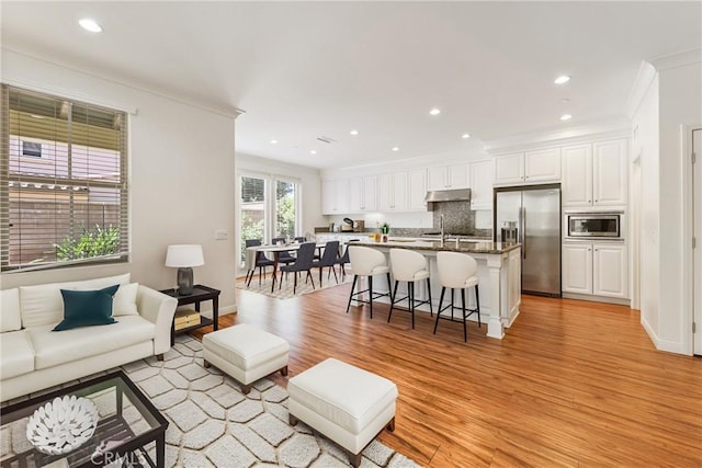 41 Somerton, Irvine, CA 92620 - living area with ornamental molding, light wood-style flooring, and recessed lighting