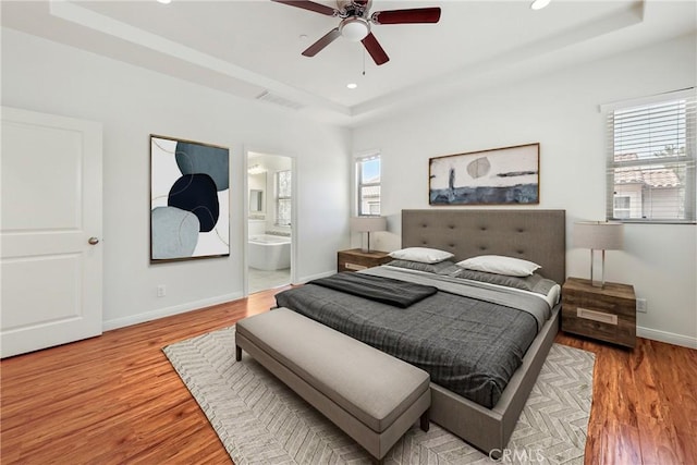 41 Somerton, Irvine, CA 92620 - bedroom with a raised ceiling, wood finished floors, recessed lighting, connected bathroom, and a ceiling fan