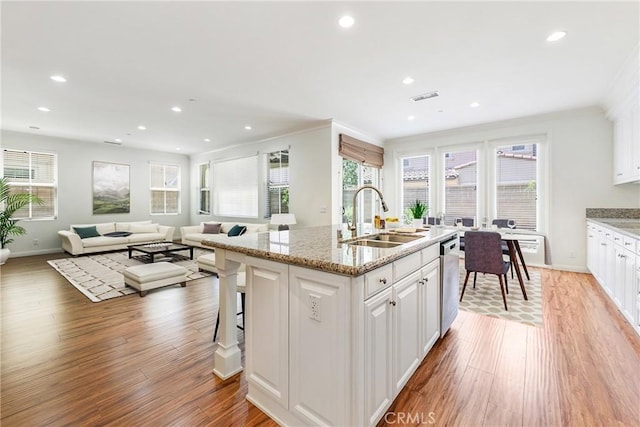 41 Somerton, Irvine, CA 92620 - kitchen featuring dishwasher, light wood-type flooring, white cabinets, recessed lighting, and ornamental molding