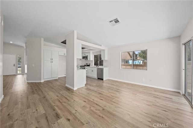 43906 Broadwater Ave, Lancaster, CA 93535 - unfurnished living room with light wood-style floors and lofted ceiling