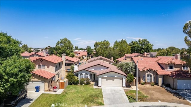 43906 Broadwater Ave, Lancaster, CA 93535 - mediterranean / spanish-style home featuring driveway, a residential view, stucco siding, a tiled roof, and a chimney