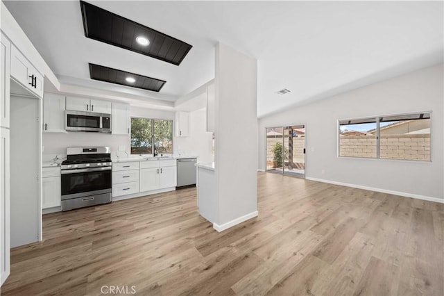 43906 Broadwater Ave, Lancaster, CA 93535 - kitchen featuring stainless steel appliances, white cabinets, light countertops, and light wood-style flooring