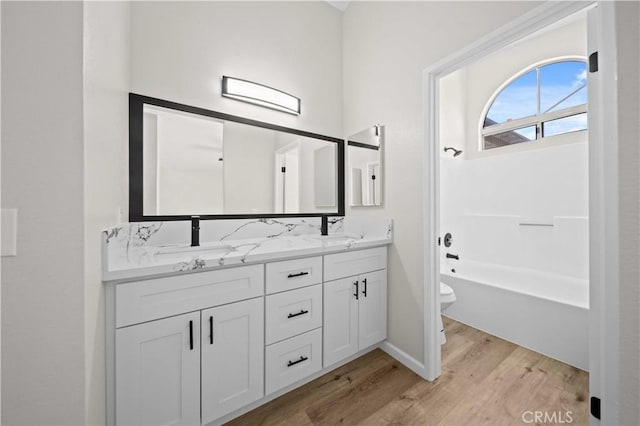 43906 Broadwater Ave, Lancaster, CA 93535 - bathroom featuring wood finished floors, double vanity, and bathing tub / shower combination