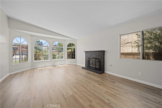 43906 Broadwater Ave, Lancaster, CA 93535 - unfurnished living room with lofted ceiling, wood finished floors, and a brick fireplace