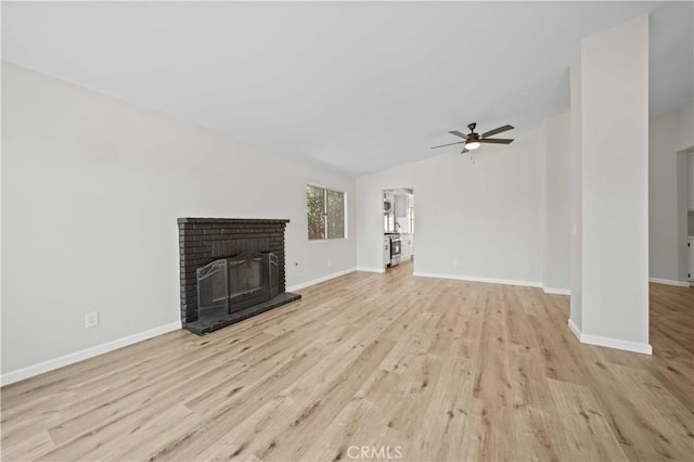 43906 Broadwater Ave, Lancaster, CA 93535 - unfurnished living room featuring wood finished floors, ceiling fan, a fireplace, and vaulted ceiling