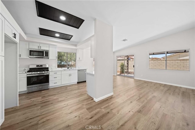 43906 Broadwater Ave, Lancaster, CA 93535 - kitchen with stainless steel appliances, white cabinets, light wood-style floors, and light countertops