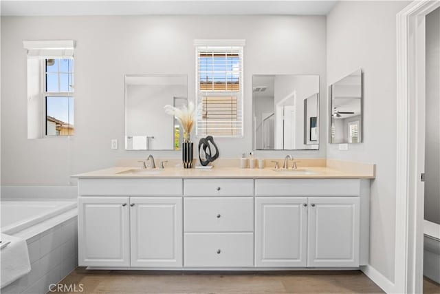 22 Lomada St, Rancho Mission Viejo, CA 92694 - bathroom featuring double vanity, a garden tub, a ceiling fan, and wood finished floors