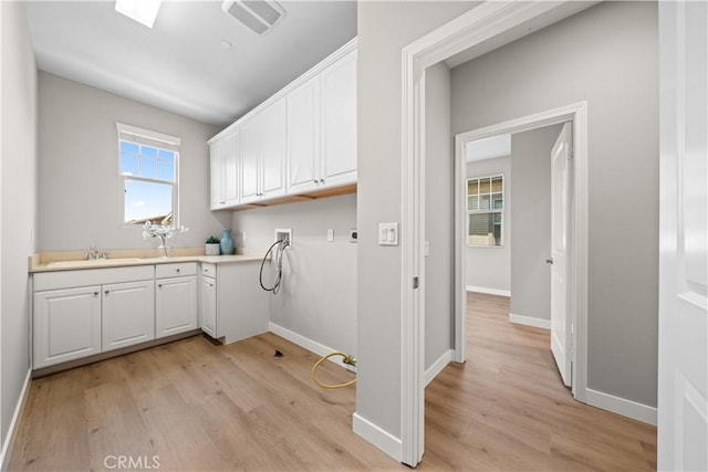 22 Lomada St, Rancho Mission Viejo, CA 92694 - washroom with hookup for a washing machine, light wood finished floors, and cabinet space