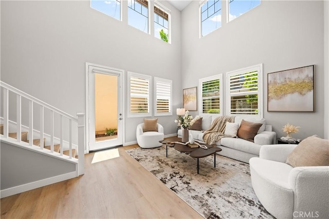 22 Lomada St, Rancho Mission Viejo, CA 92694 - living room featuring a high ceiling, wood finished floors, and stairs