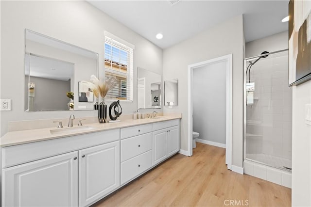 22 Lomada St, Rancho Mission Viejo, CA 92694 - bathroom with a shower stall, double vanity, wood finished floors, and recessed lighting