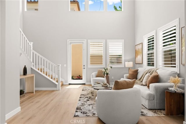 22 Lomada St, Rancho Mission Viejo, CA 92694 - living room featuring a towering ceiling, stairway, and wood finished floors