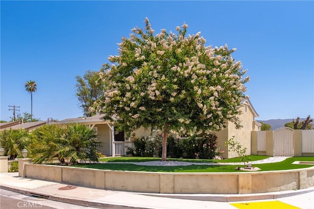 1524 Casarin Ave, Simi Valley, CA 93065 - view of property hidden behind natural elements with stucco siding and a gate
