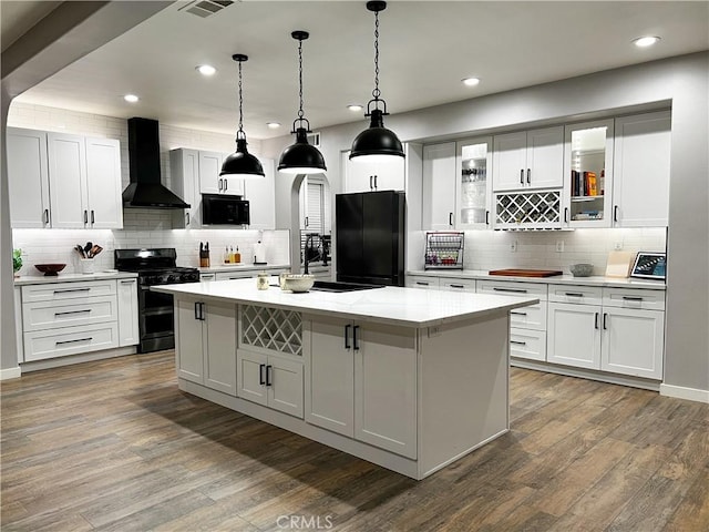5834 Gem Ct, Lancaster, CA 93536 - kitchen featuring wall chimney range hood, gas range, fridge, tasteful backsplash, and recessed lighting