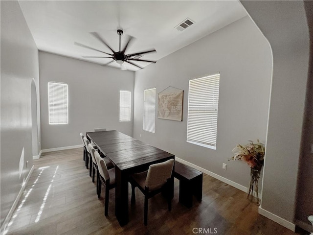 5834 Gem Ct, Lancaster, CA 93536 - dining area with arched walkways, a ceiling fan, and wood finished floors