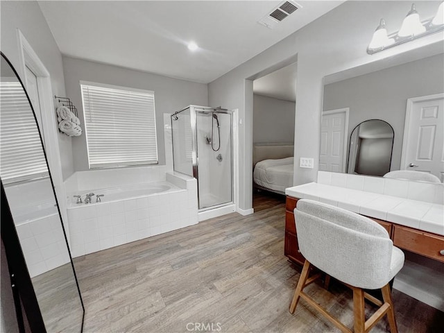 5834 Gem Ct, Lancaster, CA 93536 - ensuite bathroom with a shower stall, a bath, wood finished floors, and vanity