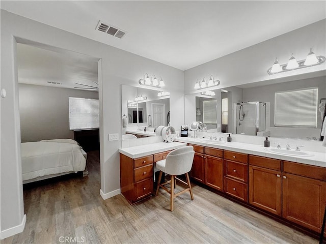 5834 Gem Ct, Lancaster, CA 93536 - ensuite bathroom with wood finished floors, a shower stall, and double vanity