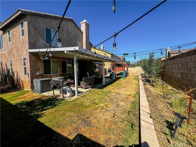 5834 Gem Ct, Lancaster, CA 93536 - back of house with a patio, a fenced backyard, stucco siding, and a chimney