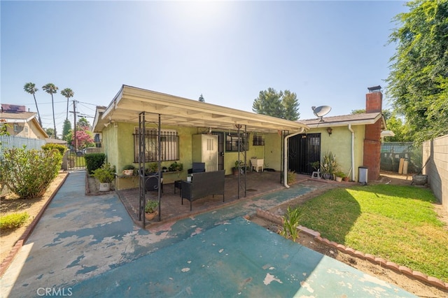 3133 Juanita St, Riverside, CA 92504 - rear view of house featuring a patio area, stucco siding, and a chimney