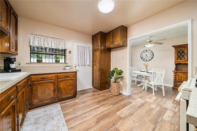 3133 Juanita St, Riverside, CA 92504 - kitchen featuring range, a ceiling fan, light countertops, and light wood-type flooring
