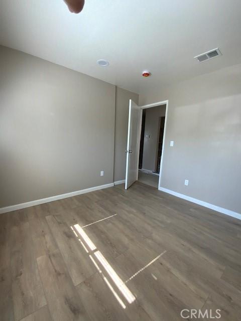 840 W 27th St, San Bernardino, CA 92405 - empty room with wood finished floors and baseboards